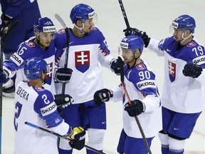 Slovakia's Richard Panik, center, celebrates with teammates after scoring his sides first goal during the Ice Hockey World Championships group A match between France and Slovakia at the Steel Arena in Kosice, Slovakia, Friday, May 17, 2019.