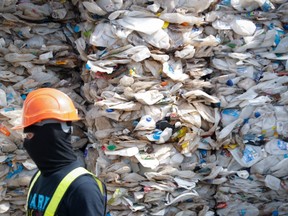 A container is filled with plastic waste from Australia, in Port Klang, Malaysia, Tuesday, May 28, 2019. Malaysia says it will send back some 3,000 metric tonnes (330 tons) of non-recyclable plastic waste to countries including the U.S., U.K., Canada and Australia in a move to avoid becoming a dumping ground for rich nations.