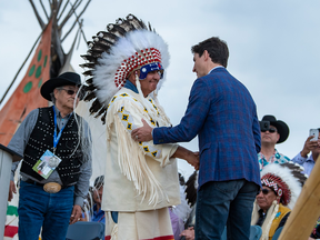 Prime Minister Justin Trudeau shakes hands with Poundmaker Chief Duane Antoine during the exoneration for Chief Poundmaker on the Poundmaker First Nation, May 23, 2019.