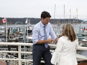 Prime Minister Justin Trudeau speaks with Liberal candidate Michelle Corfield who'll run in the upcoming federal byelection after greeting supporters in March in Nanaimo, B.C.