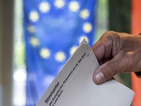 A ballot for the European elections is casted in a polling station in Berlin, Germany, Sunday, May 26, 2019.