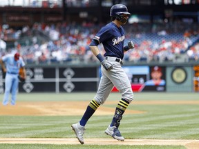 Milwaukee Brewers' Christian Yelich, right, rounds the bases after hitting a home run off Philadelphia Phillies starting pitcher Zach Eflin, left, during the first inning of a baseball game, Thursday, May 16, 2019, in Philadelphia.