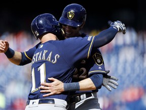 Milwaukee Brewers' Mike Moustakas, left, and Christian Yelich celebrate after Moustakas' two-run home run off Philadelphia Phillies relief pitcher Austin Davis during the ninth inning of a baseball game, Thursday, May 16, 2019, in Philadelphia. Milwaukee won 11-3.