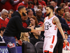 Rapper Drake high fives Toronto Raptor Fred VanVleet as he comes off the court during Game 4 against the Milwaukee Bucks.