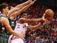 Kyle Lowry passes the ball during the second half against the Milwaukee Bucks in game three of the NBA Eastern Conference Finals at Scotiabank Arena on May 19, 2019 in Toronto.
