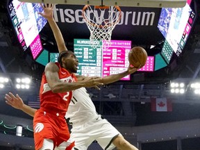 Toronto Raptors' Kawhi Leonard shoots past Milwaukee Bucks' Brook Lopez during the second half of Game 5 of the NBA Eastern Conference basketball playoff finals Thursday, May 23, 2019, in Milwaukee.