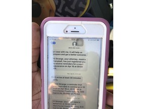 In this Tuesday April 16, 2019 photo, Strange Simon, displays her phone with reminders of cost appearances outside a courthouse, in Richmond, Va. Simon attended a recent hearing in her marijuana possession case. Simon said receiving text reminders from the public defender's office stopped her from showing up for court on the wrong day. Courts around the country are using texting services to reduce the number of defendants who fail to show up for their court hearings.