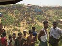 Rohingya refugees watch as firefighters douse flames after a fire broke out in the Kutupalong refugee camp in Bangladesh, April 24, 2019.