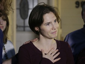 In this March 27, 2015 photo Amanda Knox talks to reporters outside her mother's home, in Seattle, WA, United States. Knox says she is returning to Italy for the first time since she was convicted and imprisoned, but ultimately acquitted, for the murder and sexual assault of her British roommate Meredith Kercher in the university hilltop town of Perugia. Knox  on Twitter that "I'm honored to accept their invitation to speak to the Italian people at this historic event and return to Italy for the first time" after she was invited to attend a conference June 14-15 in Modena organized by the Italy Innocence Project, which seeks to help people who have been convicted for crimes they did not commit.