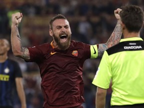 FILE - In this Oct. 2, 2016 file photo, Roma's Daniele De Rossi celebrates after his teammate Kostas Manolas scored during a Serie A soccer match between Roma and Inter Milan, at Rome's Olympic Stadium. Roma captain Daniele De Rossi surprisingly announced on Tuesday, May 14, 2019 he is leaving his hometown club after 18 years.