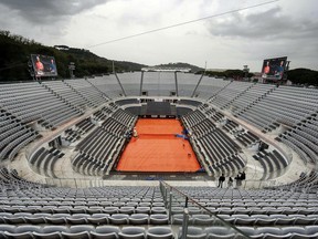 The central court is covered as all the matches are temporarily suspended due to the rain at the Italian Open tennis tournament in Rome, Wednesday, May 15, 2019.