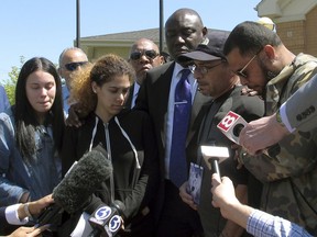 Attorney Ben Crump, center, and relatives of Anthony Jose Vega Cruz gather in Wethersfield, Conn., on Wednesday, May 8, 2019, to decry the killing of Vega Cruz by a Wethersfield police officer. Officer Layau Eulizier fatally shot Vega Cruz on April 20 as Vega Cruz drove toward the officer while fleeing a traffic stop. Eulizier's lawyer said the shooting was justified.