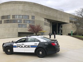 Police stand guard at the Community College of Rhode Island's campus in Warwick, R.I., which was evacuated and where classes were suspended as a precaution Wednesday morning, May 1, 2019, after a shell casing was found in a common hallway.