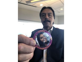 Orlando Duran, whose daughter Alexa was killed in the collapse of a pedestrian bridge at Florida International University, holds up a photo at a news conference, Friday, May 3, 2019 in Miami. Insurers will pay up to $42 million to surviving victims of a 2018 Florida bridge collapse and the families of those killed, under a deal announced Friday between the now-bankrupt construction company that built the pedestrian bridge and its insurers.