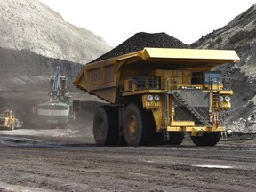 FILE - In this April 4, 2013, file photo, a truck carrying 250 tons of coal hauls the fuel to the surface of the Spring Creek mine near Decker, Mont. Federal officials say the Trump administration's decision to lift a moratorium on coal sales from public lands could hasten the release of more than 5 billion tons of greenhouse gasses. The report comes after a court ruled last month that the administration failed to consider the environmental effects of its resumption in 2017 of coal sales. A moratorium had been imposed under President Barack Obama over worries about climate change.