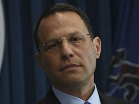 Pennsylvania's attorney general, Josh Shapiro, listens to a question at a news conference in his office headquarters, Wednesday, May 1, 2019 in Harrisburg, Pa. Shapiro announced that his office will appeal a federal judge's decision to vacate the child-endangerment conviction of former Penn State President Graham Spanier.