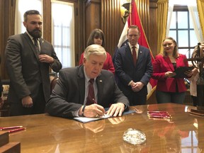 Missouri Gov. Mike Parson signs one of the nation's most restrictive abortion bills, banning the procedure on or beyond eight weeks of pregnancy, Friday, May 24, 2019 in Jefferson City, Mo.