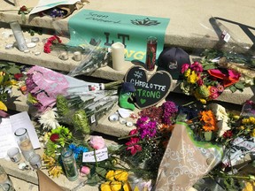 A growing memorial is seen on the steps of a building at the University of North Carolina at Charlotte, Thursday, May 2, 2019. A gunman opened fire in a classroom on Tuesday, killing two and wounding four.