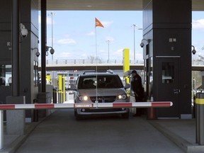 A customs officer stands by a vehicles crossing through the U.S. border post on Wednesday May 8, 2019, at the new border crossing facility on the U.S.-Canadian border at Derby Line, Vt. The new, energy efficient border post at the northern end of Interstate 91 that processes about 1.1 million people a year as well as cargo, is designed to ensure the free-flow of people and commerce between the two countries.