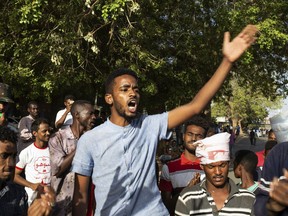 A group of protesters repeat revolutionary chants against military rule and demand the prosecution of members of the ousted government of long-ruling President Omar al-Bashir, at the Armed Forces Square, in Khartoum, Sudan, Tuesday, April 30, 2019. Sudan's ruling military council on Tuesday warned protesters against any further "chaos" as organizers called for mass rallies later this week.