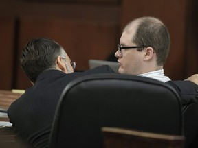 Defense attorney Casey Secor talks with Timothy Jones Jr., right, during his trial in Lexington, S.C., Wednesday, May 29, 2019. Jones is accused of killing his five children in 2014. Jones, who faces the death penalty, has pleaded not guilty by reason of insanity.
