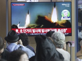 People watch a TV showing a file footage of North Korea's missile launch during a news program at the Seoul Railway Station in Seoul, South Korea, Saturday, May 4, 2019. North Korea on Saturday fired several unidentified short-range projectiles into the sea off its eastern coast, the South Korean Joint Chiefs of Staff said, a likely sign of Pyongyang's growing frustration at stalled diplomatic talks with Washington meant to provide coveted sanctions relief in return for nuclear disarmament. The signs read: " North Korea fired short-range missiles."