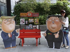 Caricatures depicting U.S. President Donald Trump, left, and North Korean leader Kim Jong Un are displayed in Seoul, South Korea, Sunday, May 26, 2019. In an apparent contradiction of his national security adviser, President Donald Trump on Sunday downplayed recent North Korean missile tests, tweeting from Tokyo that they're not a concern for him in comments sure to unnerve Japanese leaders.