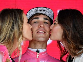 Italy's Valerio Conti celebrates on the podium wearing the overall leader's pink jersey after the sixth stage of the Giro D'Italia, tour of Italy cycling race, from Cassino to San Giovanni Rotondo, Thursday, May 16, 2019.