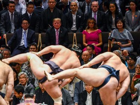 US President Donald Trump and First Lady Melania Trump are accompanied by Japan's Prime Minister Shinzo Abe and his wife Akie Abe as they watch a sumo demonstration during the Summer Grand Sumo Tournament in Tokyo on May 26, 2019.