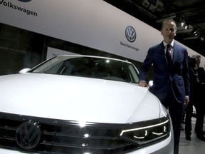 Herbert Diess, CEO of the Volkswagen stock company, poses next to a Volkswagen car prior to the company's annual general meeting in Berlin, Germany, Tuesday, May 14, 2019.