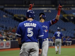Toronto Blue Jays' Lourdes Gurriel Jr. celebrates his two-run home run with teammate Eric Sogard (5) off Tampa Bay Rays starting pitcher Blake Snell during the first inning of a baseball game Wednesday, May 29, 2019, in St. Petersburg, Fla.