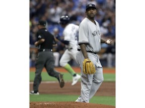 New York Yankees starting pitcher CC Sabathia, right, walks behind the mound as Tampa Bay Rays' Avisail Garcia runs the bases after hitting a home run during the second inning of a baseball game Saturday, May 11, 2019, in St. Petersburg, Fla.