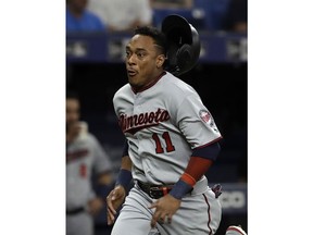 Minnesota Twins' Jorge Polanco loses his helmet as he scores on a single by Willians Astudillo off Tampa Bay Rays relief pitcher Jalen Beeks during the fifth inning of a baseball game Friday, May 31, 2019, in St. Petersburg, Fla.