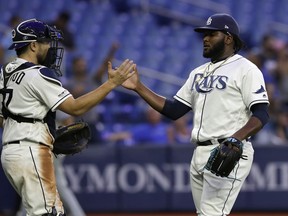 Tampa Bay Rays relief pitcher Diego Castillo, right, celebrates with catcher Travis d'Arnaud after closing out the Toronto Blue Jays during the ninth inning of a baseball game, Tuesday, May 28, 2019, in St. Petersburg, Fla.