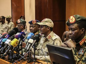 FILE - In this April 30, 2019 file photo, Gen. Mohamed Hamdan Dagalo, the deputy head of the military council, second right, speaks at a press conference in Khartoum, Sudan. Sudan's ruling military council is meeting with protesters on Sunday, May19, 2019, to discuss the country's political transition after talks were halted for three days while roads were cleared outside the main sit-in in the capital, Khartoum. (AP Photo)