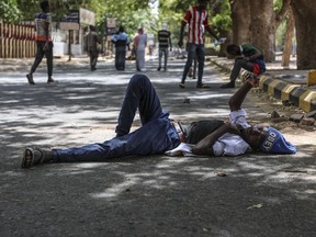 A protester takes a rest in a street leading to the sitin outside the Sudanese military headquarters, in Khartoum, Sudan, Tuesday, May 14, 2019. Sudanese protesters say security agents loyal to ousted President Omar al-Bashir attacked their sit-ins overnight, setting off clashes that left six people dead, including an army officer, and heightened tensions as the opposition holds talks with the ruling military council. Both the protesters and the transitional military council say the violence was instigated by al-Bashir loyalists from within the security forces. (AP Photo)