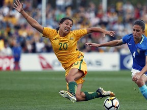 FILE - In this Sept. 16, 2017, file photo, Australia's Sam Kerr, left, fights for the ball against Brazil's Rafaelle Carvalho Souzav during their friendly soccer match in Penrith, Australia. Kerr has been selected as captain of Australia's 23-player squad for the Women's World Cup which kicks off in June 2019, in France.