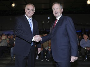 Australian Prime Minister Scott Morrison, left, and opposition leader Bill Shorten shake hands before the Sky News/Courier Mail People's Forum in Brisbane, May 3, 2019. Scandals surrounding candidates have become distractions for Morrison and Shorten this week as they attempt to focus voters on policies ahead of the May 18 election.