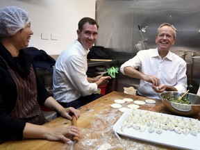 Australian Labour Party leader Bill Shorten, right, and local Labor candidate Sam Crosby, center, make dumplings during a visit to a Chinese restaurant in Sydney, Thursday, May 16, 2019. A federal election will be held in Australian on Saturday May 18, 2019.