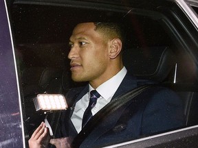 Australian rugby union player Israel Folau leaves a Code of Conduct hearing in Sydney, Sunday, May 5, 2019. The 30-year-old Folau appeared before the hearing to fight Rugby Australia's decision to terminate his contract after he posted in mid-April on social media that gay people, along with other "sinners," will face damnation unless they repent.