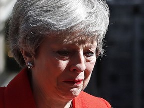 British Prime Minister Theresa May reacts as she turns away after making a speech in the street outside 10 Downing Street in London, England, Friday, May 24, 2019. Theresa May says she'll quit as UK Conservative leader on June 7, sparking contest for Britain's next prime minister.