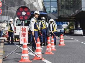 Japanese police check passersby near Haneda airport in Tokyo Thursday, May 23, 2019, ahead of planned visit by U.S. President Donald Trump. Trump is scheduled to visit Japan from May 25 until May 28.