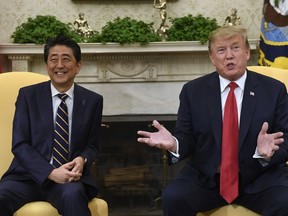 FILE - In this April 26, 2019, file photo, U.S. President Donald Trump, right, speaks while meeting with Japanese Prime Minister Shinzo Abe, left, in the Oval Office of the White House in Washington. Trump's Japan visit starting on Saturday, May 25, 2019, is to focus on personal ties with Abe rather than substantive results on trade, security or North Korea.