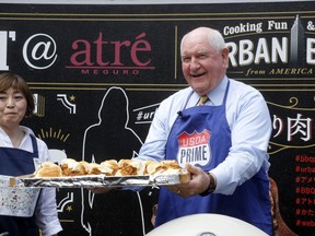 U.S. Secretary of Agriculture Sonny Perdue serves sandwiches with American meat in Tokyo Monday, May 13, 2019. Perdue barbecued American beef in Tokyo to highlight his message: Japan must treat the U.S. fairly as a top customer for Japanese products.