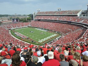 In this Sept. 5, 2015, photo, Georgia fans watch the season opening game against Louisiana Monroe at Sanford Stadium during an NCAA college football game in Athens, Ga. Some University of Georgia fans will be able to buy beer during football games - but only donors who have agreed to give tens of thousands of dollars will be allowed to drink. UGA Athletic Director Greg McGarity told the Atlanta Journal-Constitution on Wednesday, May 29, 2019, that beer and wine will be sold in Sanford Stadium's premium seating area during the 2019 football season.