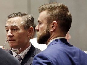 FILE - In this May 2, 2019, file photo, House Speaker Glen Casada, R-Franklin, left, talks with Cade Cothren, right, his chief of staff, during a House session in Nashville, Tenn. Cothren has resigned amid allegations of racist and sexually explicit texts.