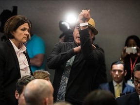 William George, a member of the Tsleil-Waututh First Nation, gestures at Prime Minister Justin Trudeau after interrupting his speech at a fundraising lunch in Vancouver, on Wednesday May 22, 2019.