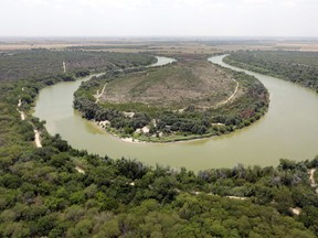 FILE - In this July 24, 2014, file photo, a bend in the Rio Grand is viewed from a Texas Department of Public Safety helicopter on patrol over in Mission, Texas. The U.S. government says a teenage Guatemalan died Monday, May 20, 2019, at a Border Patrol station in South Texas, the fifth death of a migrant child since December. U.S. Customs and Border Protection said in a statement that Border Patrol apprehended the teenager in South Texas' Rio Grande Valley on May 13. The agency says the teenager was found unresponsive Monday morning during a welfare check at the agency's Weslaco, Texas, station. The teenager's cause of death is unknown.
