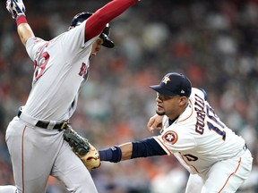 Boston Red Sox's Michael Chavis, left, is tagged out by Houston Astros first baseman Yuli Gurriel (10) during the fourth inning of a baseball game Saturday, May 25, 2019, in Houston.