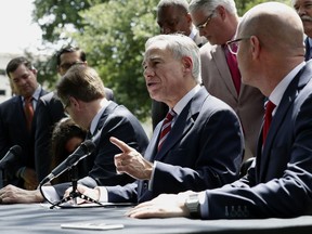 Gov. Greg Abbott, center, is joined by Lt. Gov. Dan Patrick, left, and Speaker of the House Dennis Bonnen, right, and other law makers for a joint news conference to discuss teacher pay and school finance at the Texas Governor's Mansion in Austin, Texas, Thursday, May 23, 2019, in Austin.